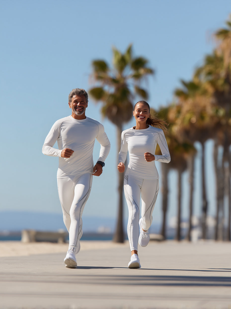Two people running on a path with palm trees in the background