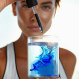 A Person holding a dropper over a glass of BioEon Methylene Blue